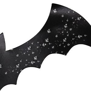 Black magnetic bat decoration with water droplets, close-up on white background
