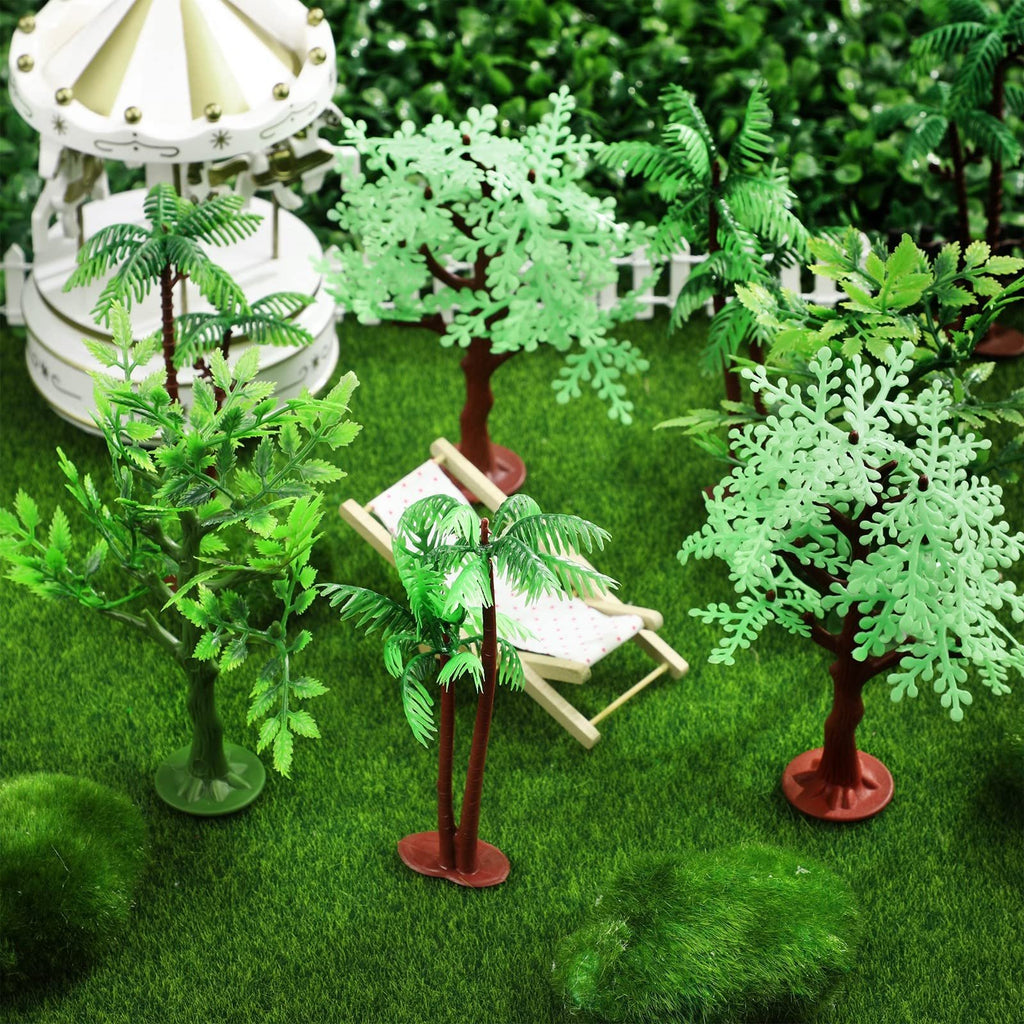 Miniature jungle trees and a carousel set on artificial grass with a tiny lounge chair.