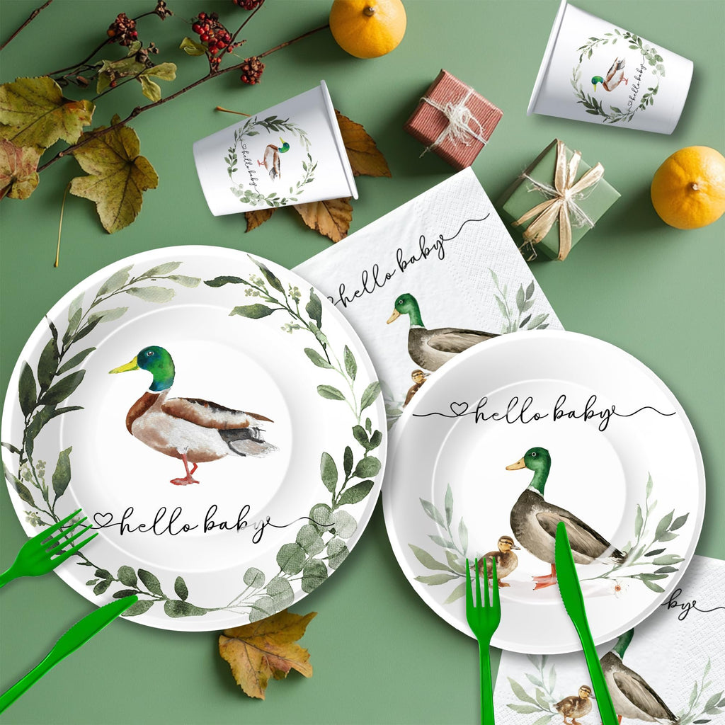 Mallard duck themed baby shower party plates, cups, and napkins with green cutlery and decorative elements.