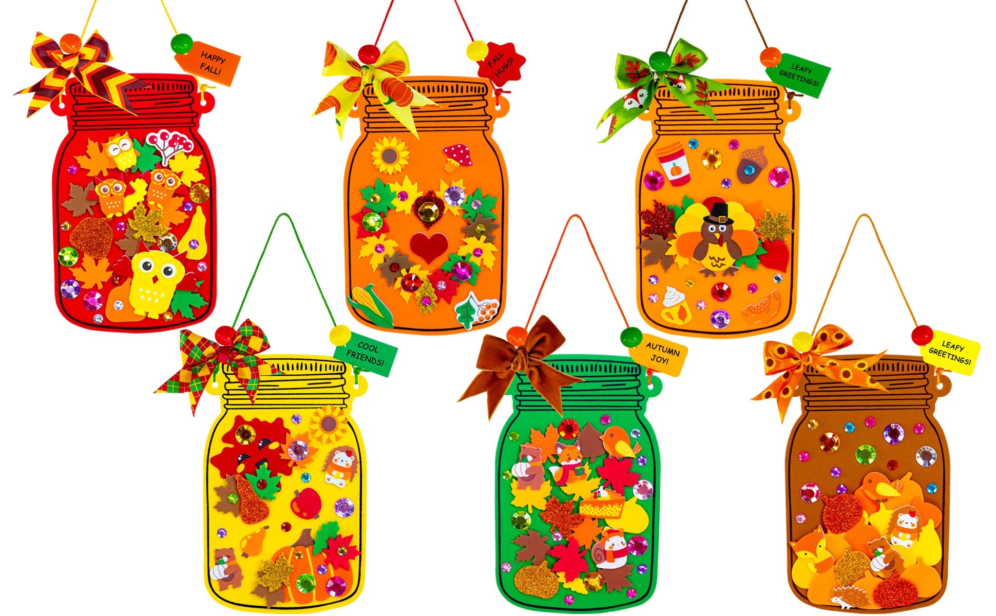 Six fall mason jar craft ornaments decorated with autumn themed foam stickers and gems, hanging with bows.