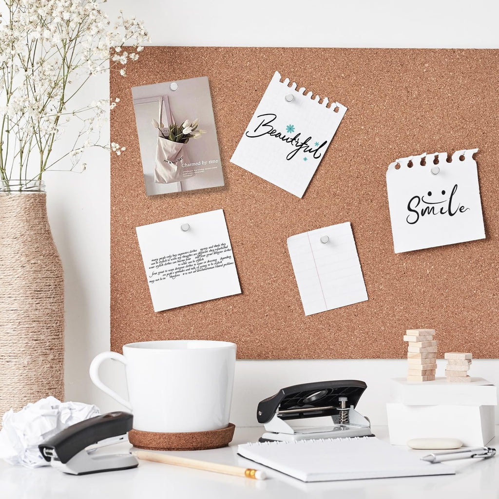 Cork board with various notes and photos pinned, including a vase of flowers, a coffee mug, and office supplies on a desk.