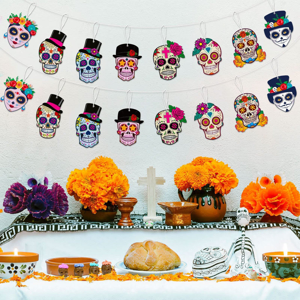 Day of the Dead altar setup with sugar skull crafts hanging and decorated with flowers, bread, and candles.