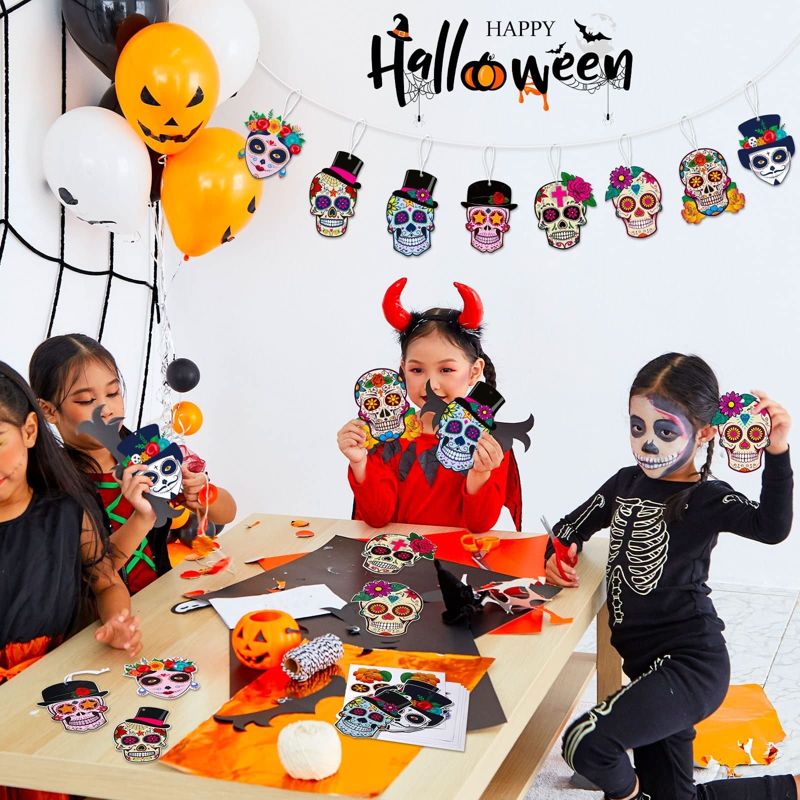 Children crafting sugar skull decorations for Halloween, with balloons and a banner in the background.