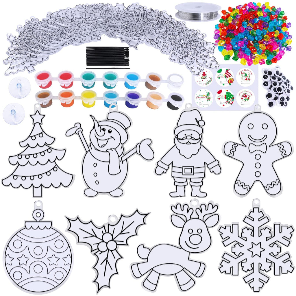 Christmas suncatcher craft kit with paints, beads, brushes, and various holiday shapes including a tree, snowman, Santa, gingerbread man, ornament, holly, reindeer, and snowflake.
