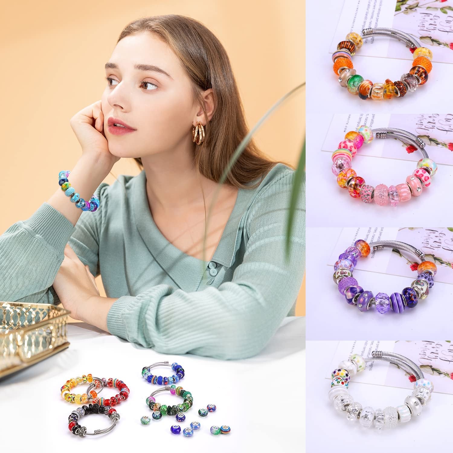 Woman wearing a colorful bracelet made of lampwork beads, with other bracelets and loose beads displayed on a table.