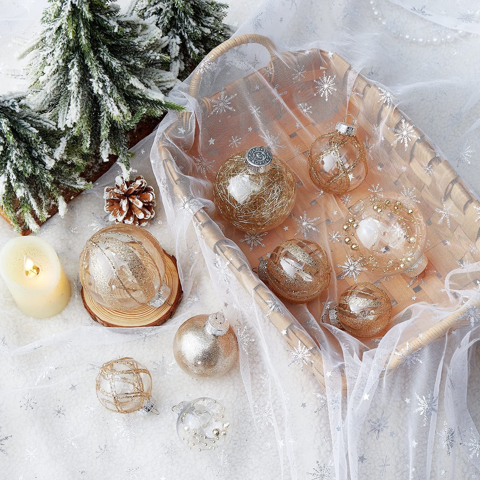 Clear plastic Christmas ball ornaments with glitter fill and gold string accents, arranged with festive decor.