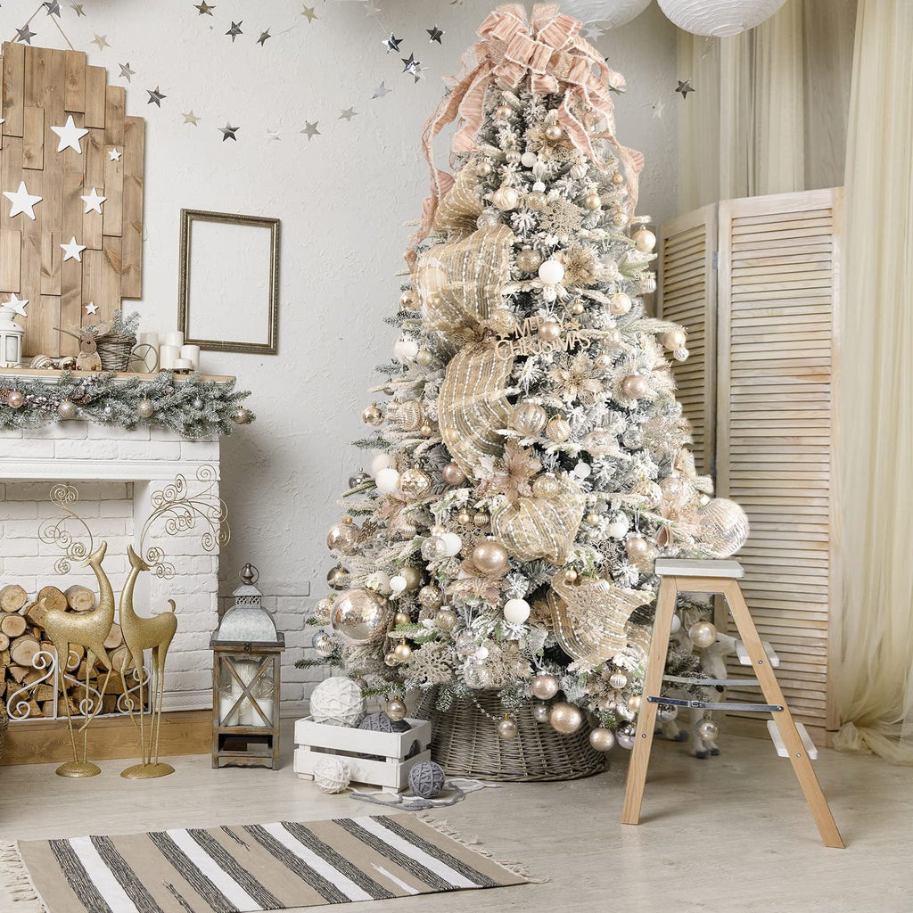 Decorated Christmas tree with champagne and gold ornaments, fireplace, and reindeer figures.