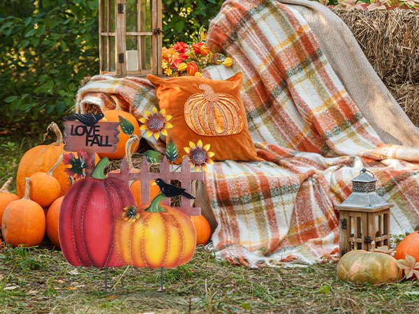 Decorative metal fall garden stakes with pumpkins, sunflowers, crows, and 'I LOVE FALL' sign in a rustic outdoor setting.