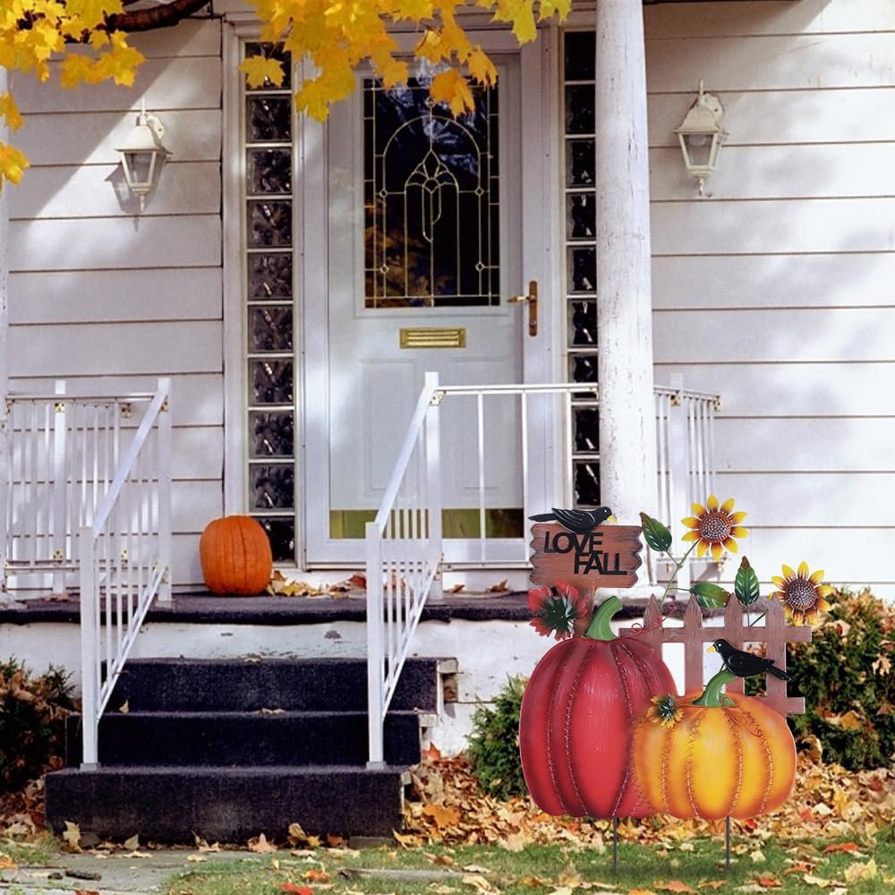 Decorative metal fall garden stakes with pumpkins, sunflowers, crows, and 'I LOVE FALL' sign placed on a lawn in front of a house porch.