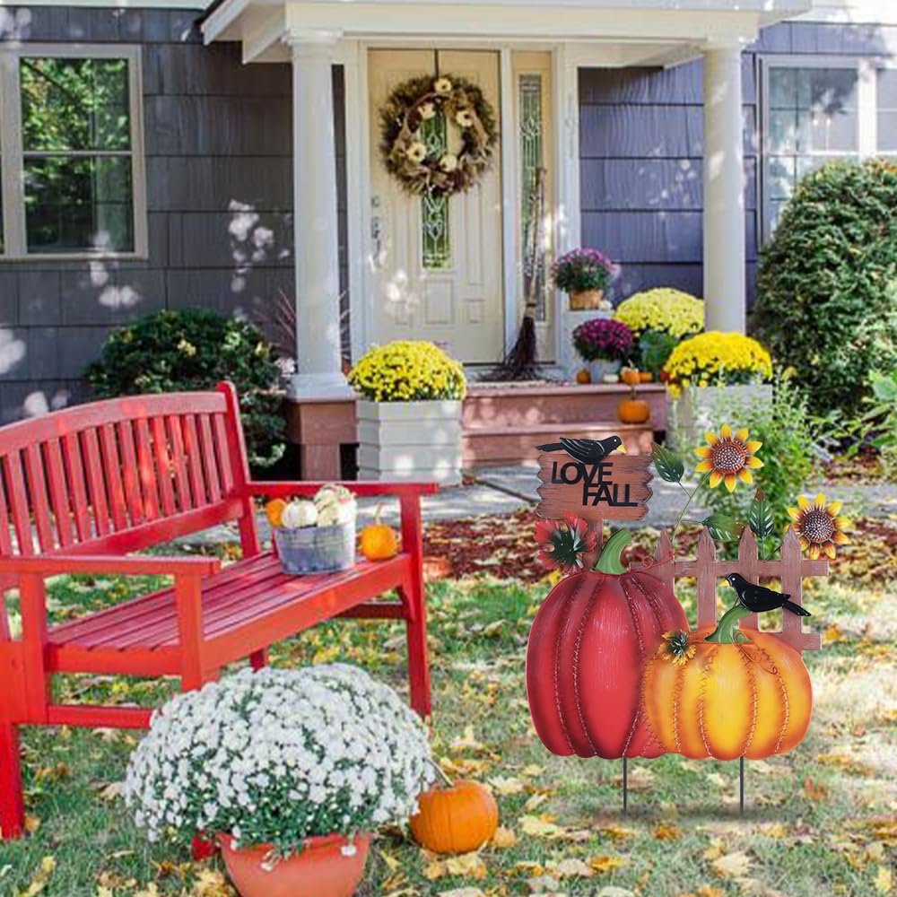Decorative metal garden stake with pumpkins, sunflowers, crows, and 'I LOVE FALL' sign in a yard setting.