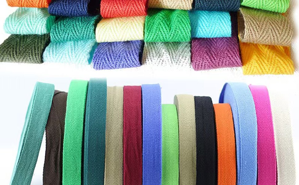 Collection of colorful cotton twill tape rolls and spools in various herringbone patterns and solid colors.