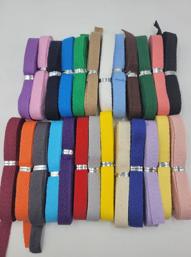 Assortment of 25 colors of herringbone twill tape rolls on a white background.