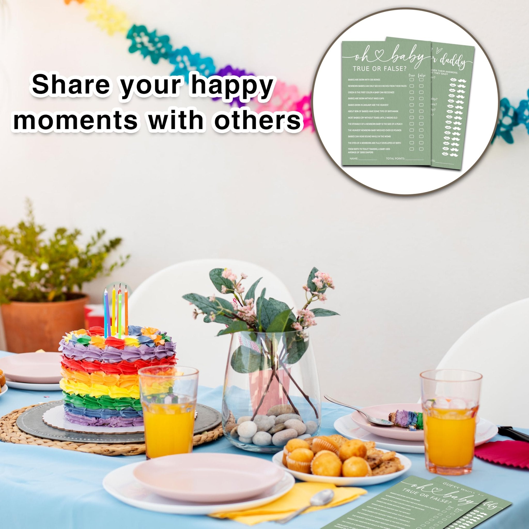 Baby shower party table setting with a rainbow cake, orange juice, cupcakes, and game cards. A banner reads 'Share your happy moments with others'.