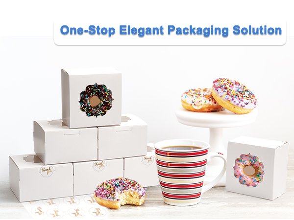 Stack of white bakery boxes with clear windows, some containing donuts, next to a mug of coffee and donuts on a stand.