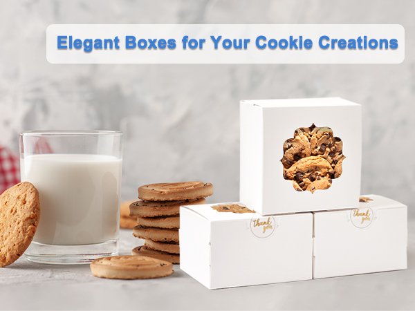 White bakery boxes with clear windows filled with cookies, next to a glass of milk and cookies.