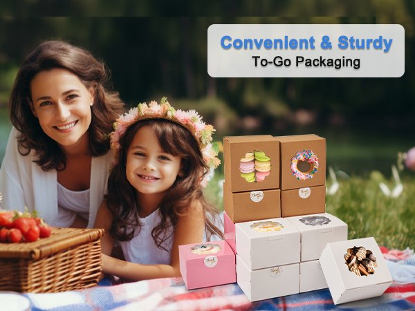 Mother and daughter at a picnic with treat boxes filled with cookies and macarons