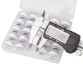 Digital caliper measuring a white prewound bobbin thread in a clear storage case with multiple bobbins.