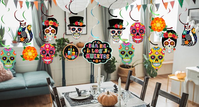 Day of the Dead sugar skull cutouts and cat decorations hanging above a dining table set for a party.