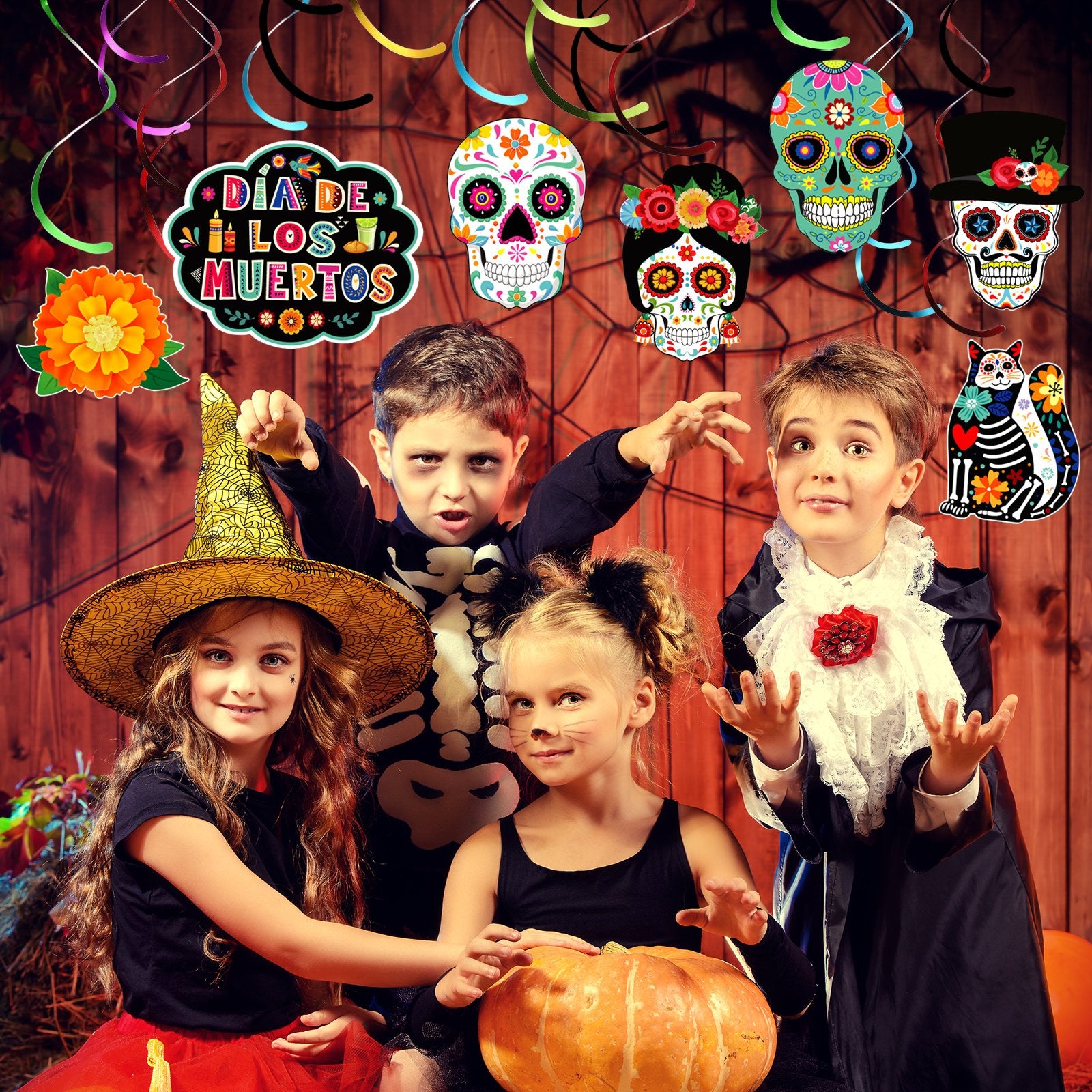 Four children in Halloween costumes pose with Day of the Dead sugar skull decorations and a pumpkin.