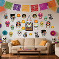 Day of the Dead sugar skull cutouts and papel picado banners decorating a living room wall above a sofa.