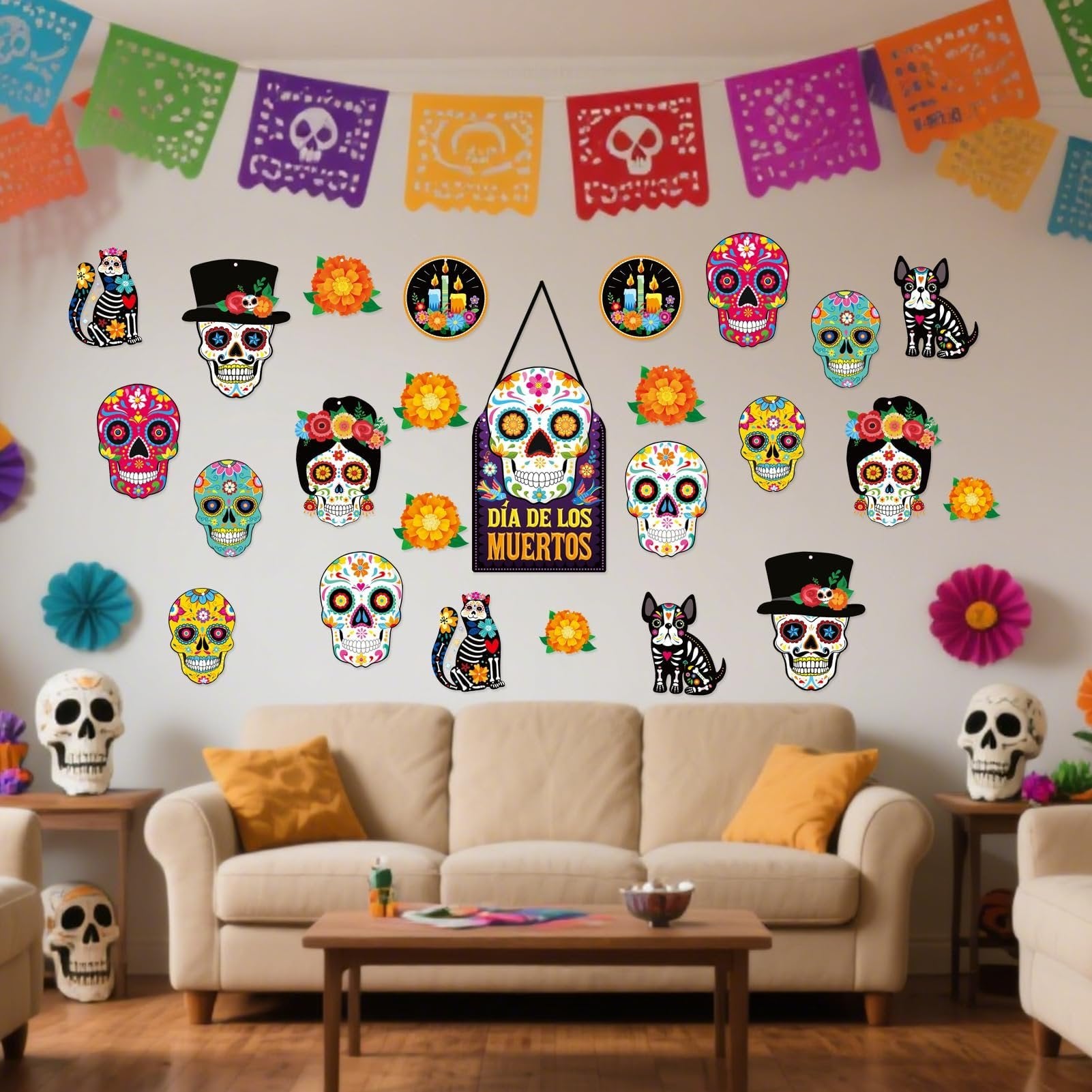 Day of the Dead sugar skull cutouts and papel picado banners decorating a living room wall above a sofa.