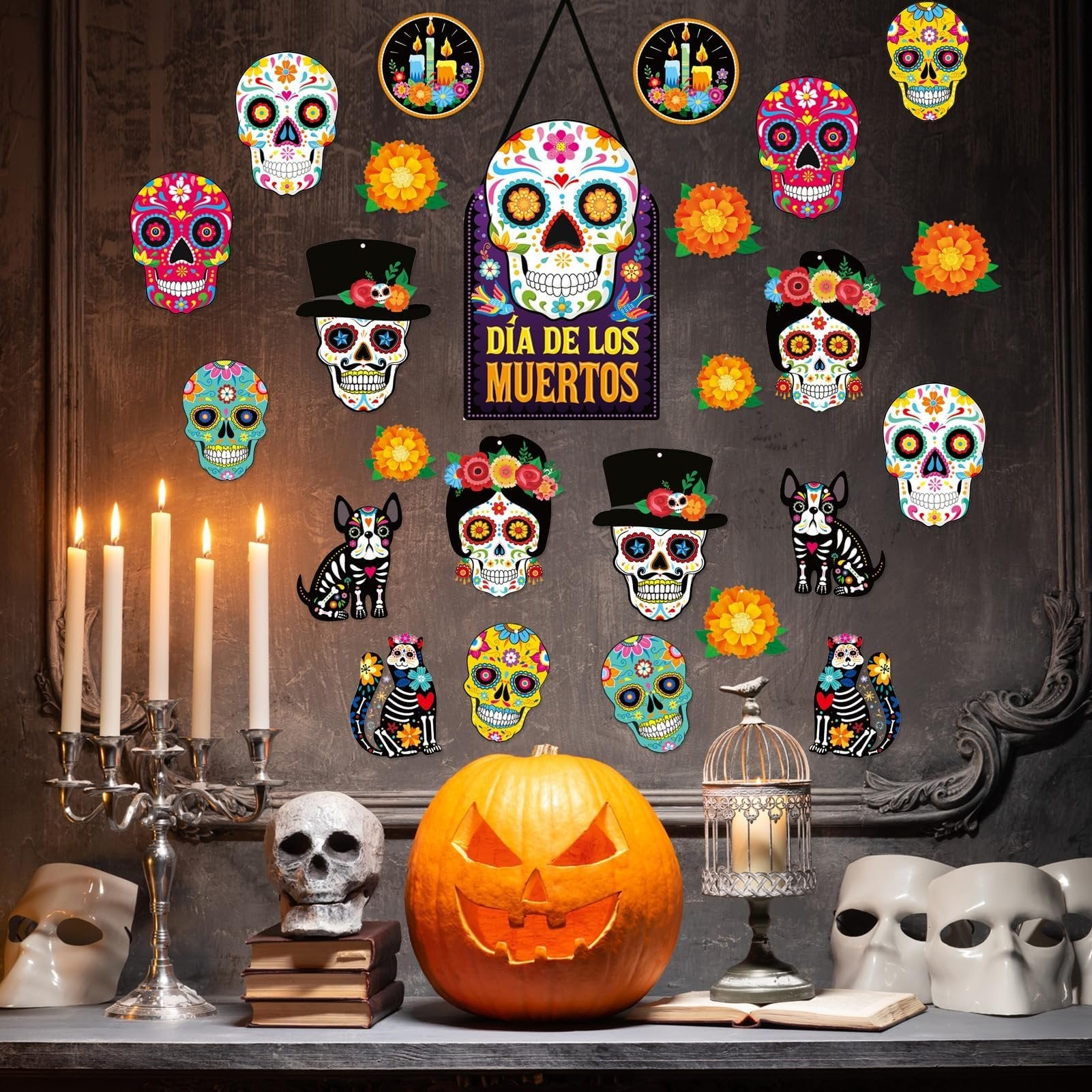 Day of the Dead sugar skull cutouts and decorations arranged on a wall with a jack-o'-lantern and skulls below.