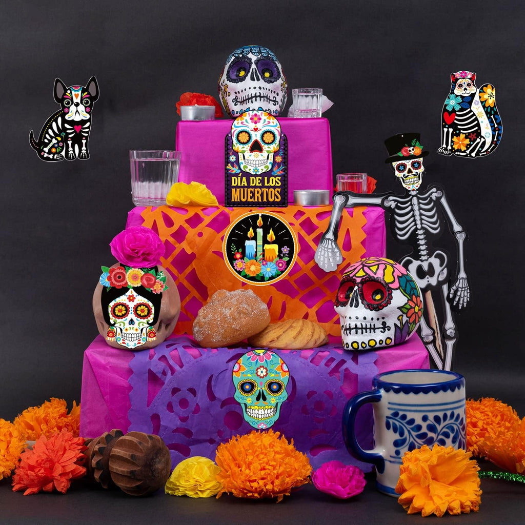 Day of the Dead altar setup with sugar skulls, skeleton figure, dog and cat cutouts, bread, and marigolds