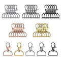Assortment of swivel clasp hooks and D-ring keychain hardware in silver, rose gold, gold, and black finishes, displayed in rows.