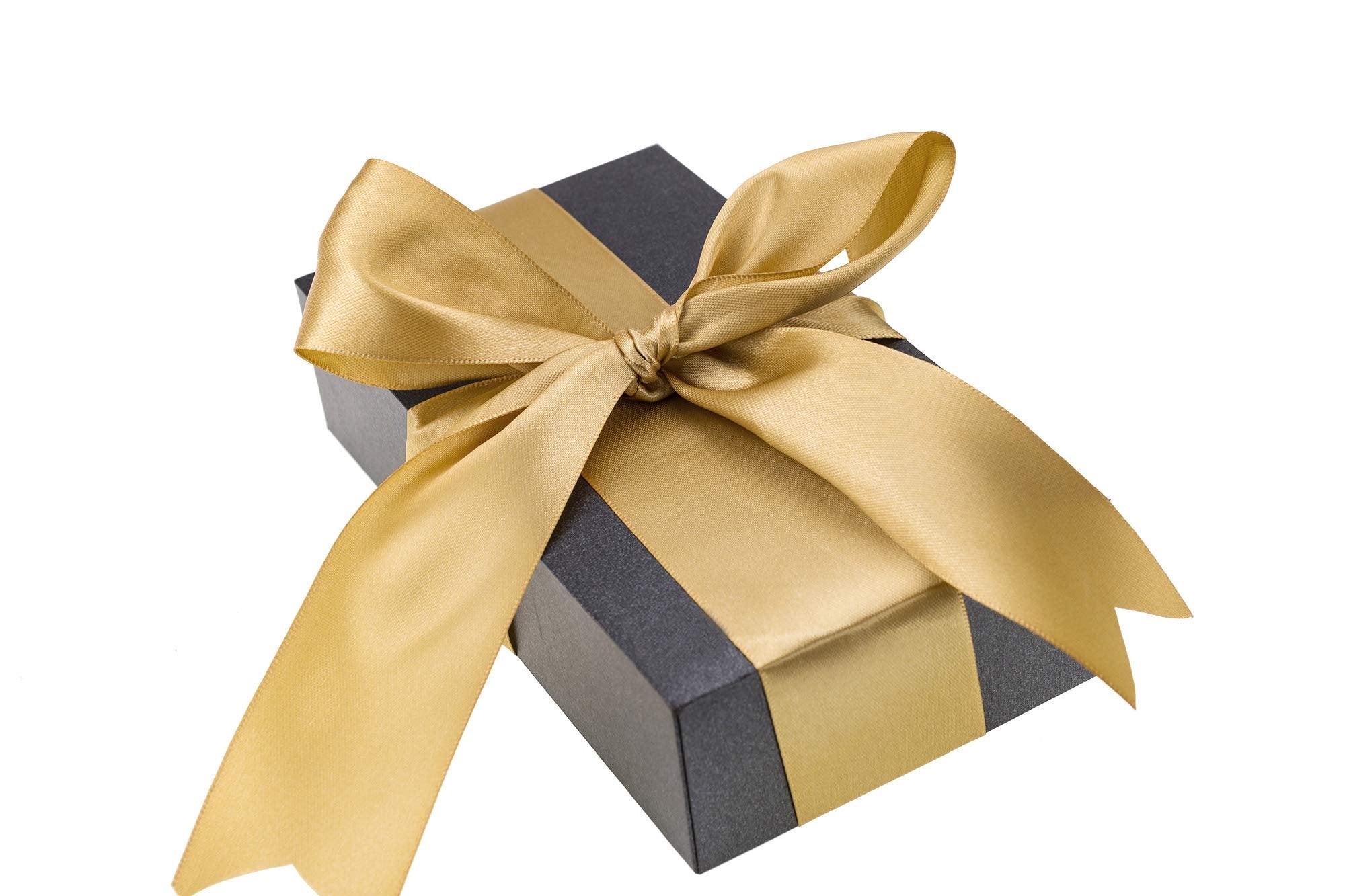 Dark gray gift box with a gold satin ribbon tied in a bow, isolated on white background.