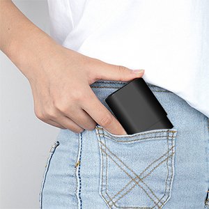 Person placing a black USB-C fast wall charger into a jeans pocket