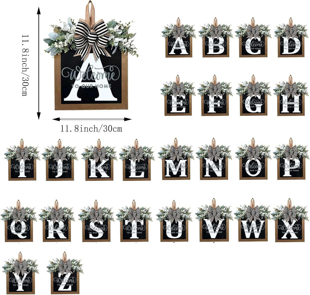 Collection of 26 wooden door hangers, each featuring a letter of the alphabet, eucalyptus garland, bow, and 'Welcome to Our Home' text.