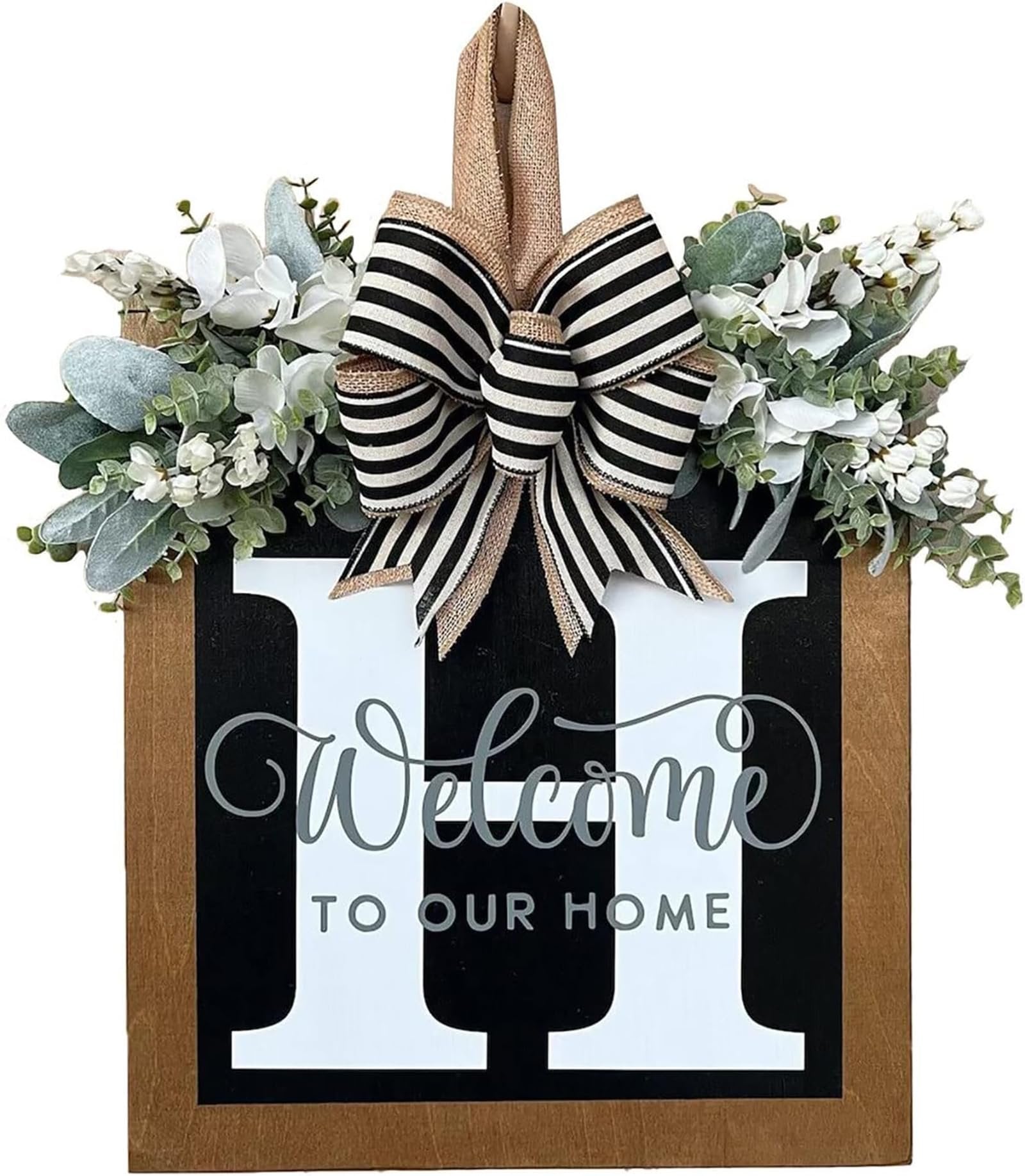 Front door wreath with eucalyptus garland, white flowers, and a black and white striped bow, featuring large white letters and 'Welcome to Our Home' text.
