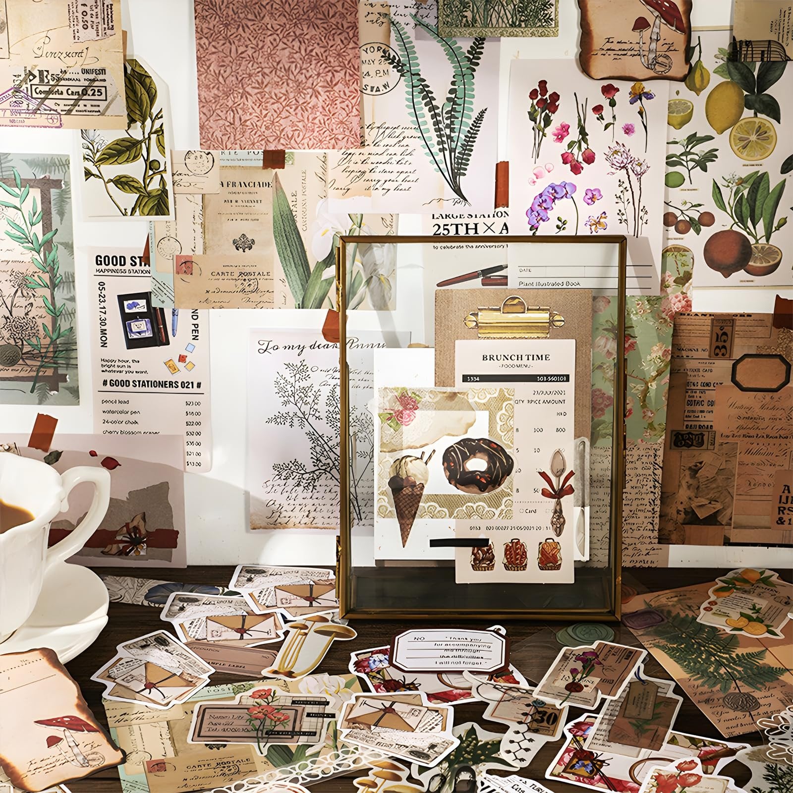 Scrapbooking supplies kit with vintage papers, stickers, and washi tape arranged on a wooden surface with a cup of coffee.