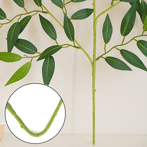 Close-up of artificial Italian Ruscus greenery stems with green leaves and a detailed view of a stem joint.