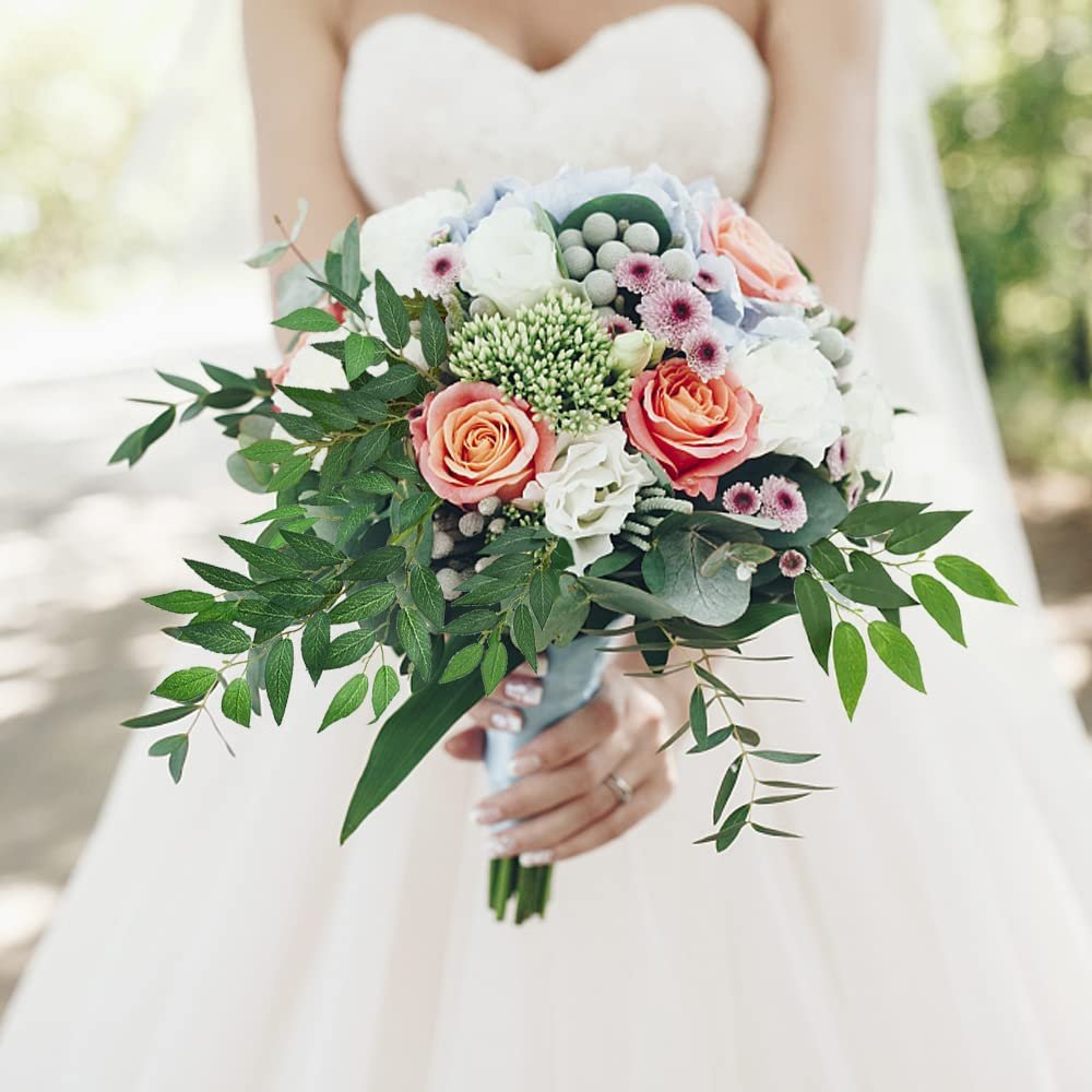 Bride holding a bouquet of artificial Italian Ruscus greenery stems and flowers