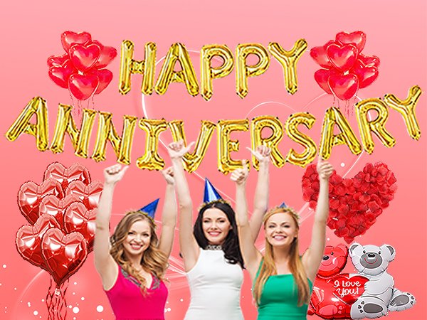 Three women celebrating with gold foil 'Happy Anniversary' balloons and red heart balloons.