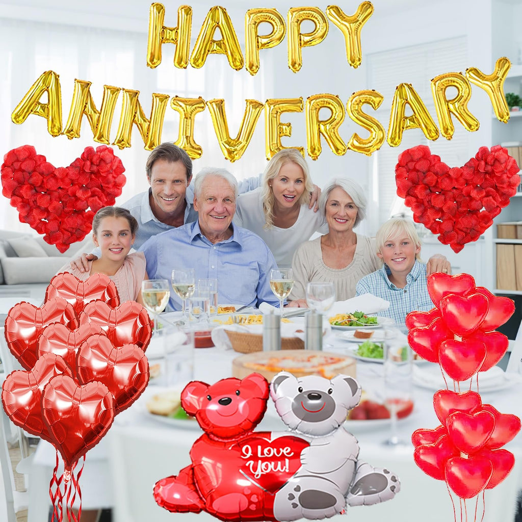 Family celebrating anniversary with gold foil balloons and red heart decorations