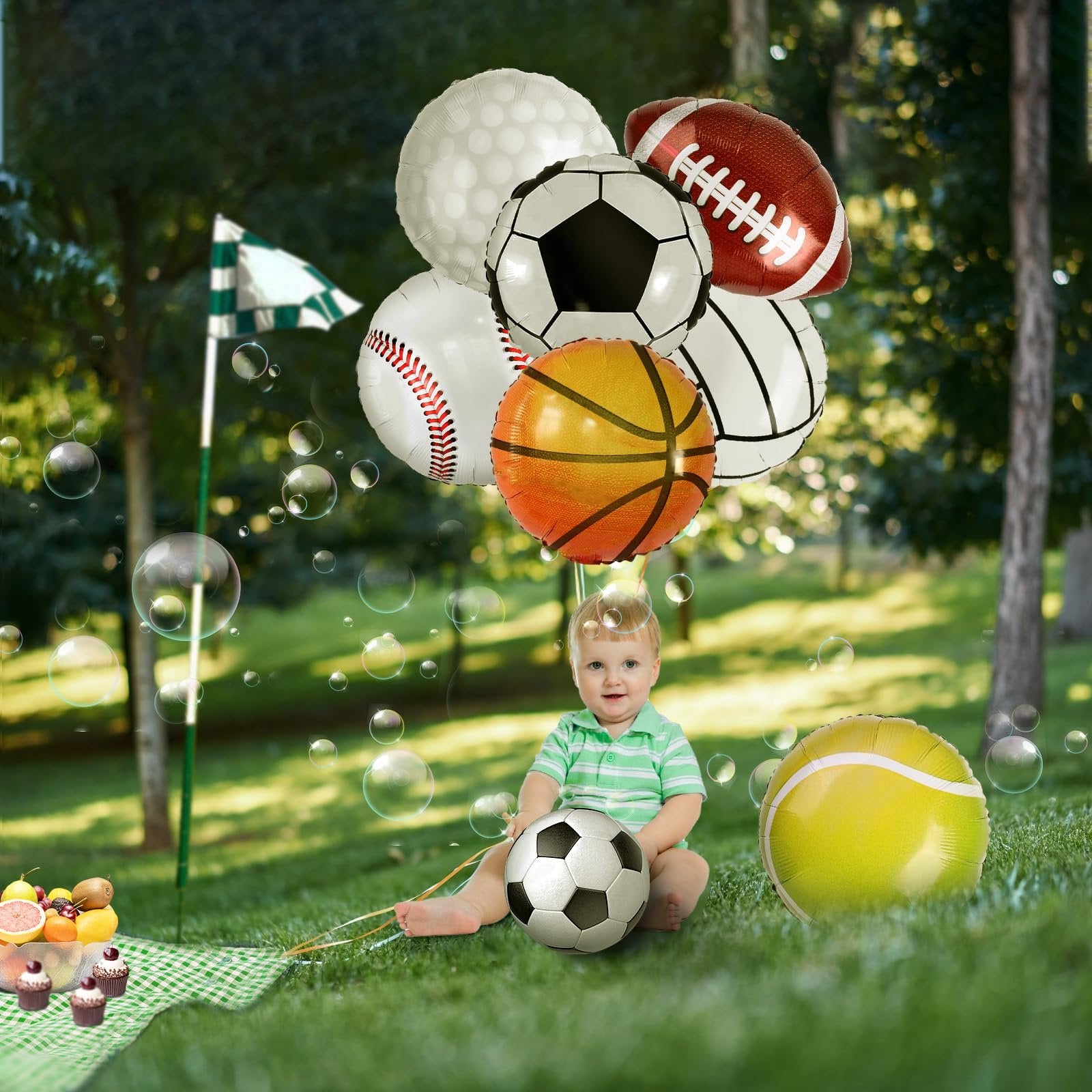 Baby sitting on grass with sports-themed balloons including baseball, basketball, soccer, football, golf, and tennis designs.