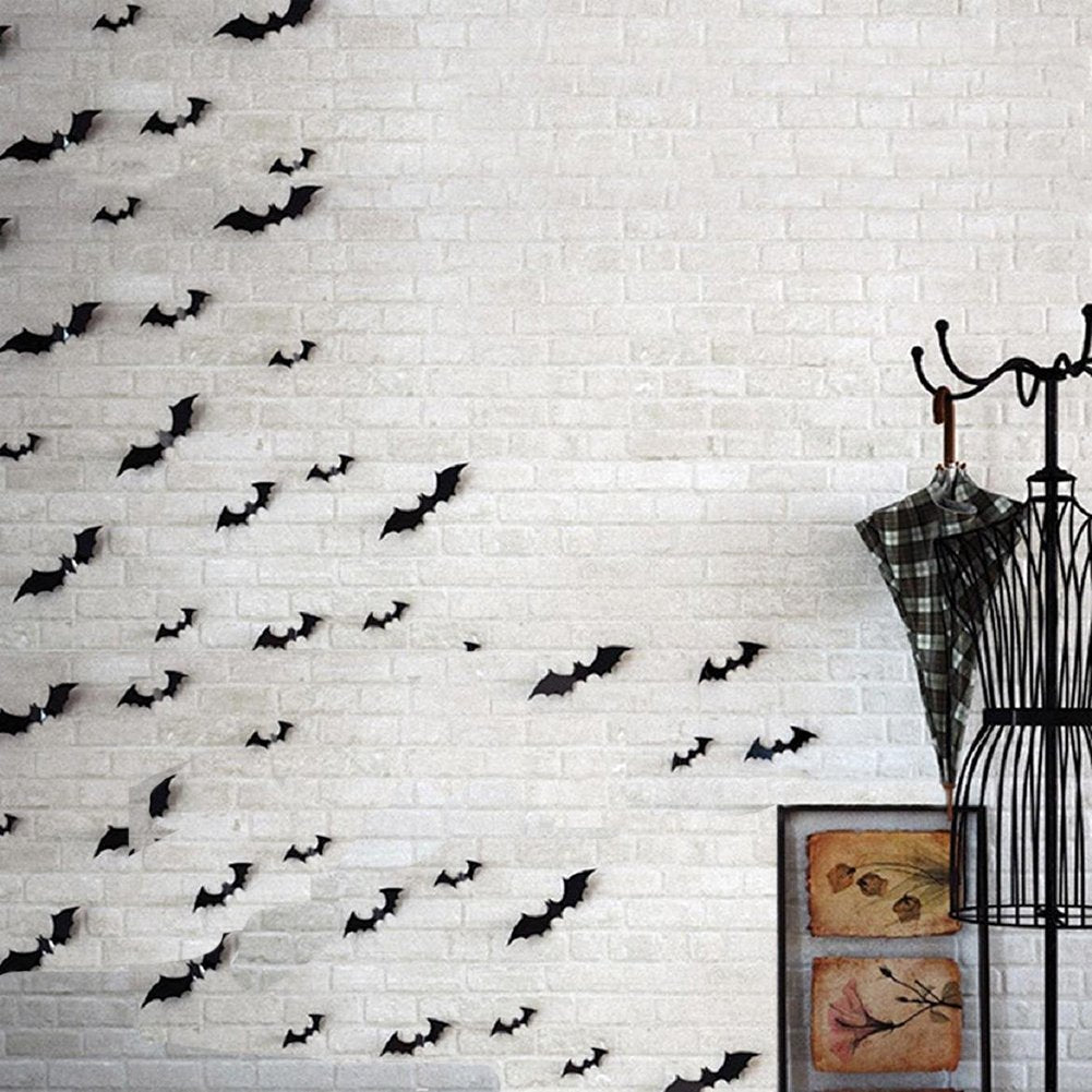 Black PVC 3D bat wall decals arranged on a white brick wall, with a mannequin and framed art to the right.