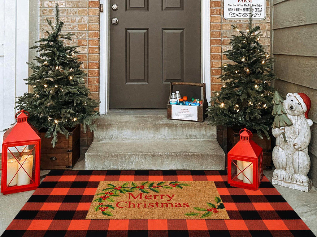 Buffalo plaid rug and Merry Christmas doormat on a porch with Christmas trees and lanterns