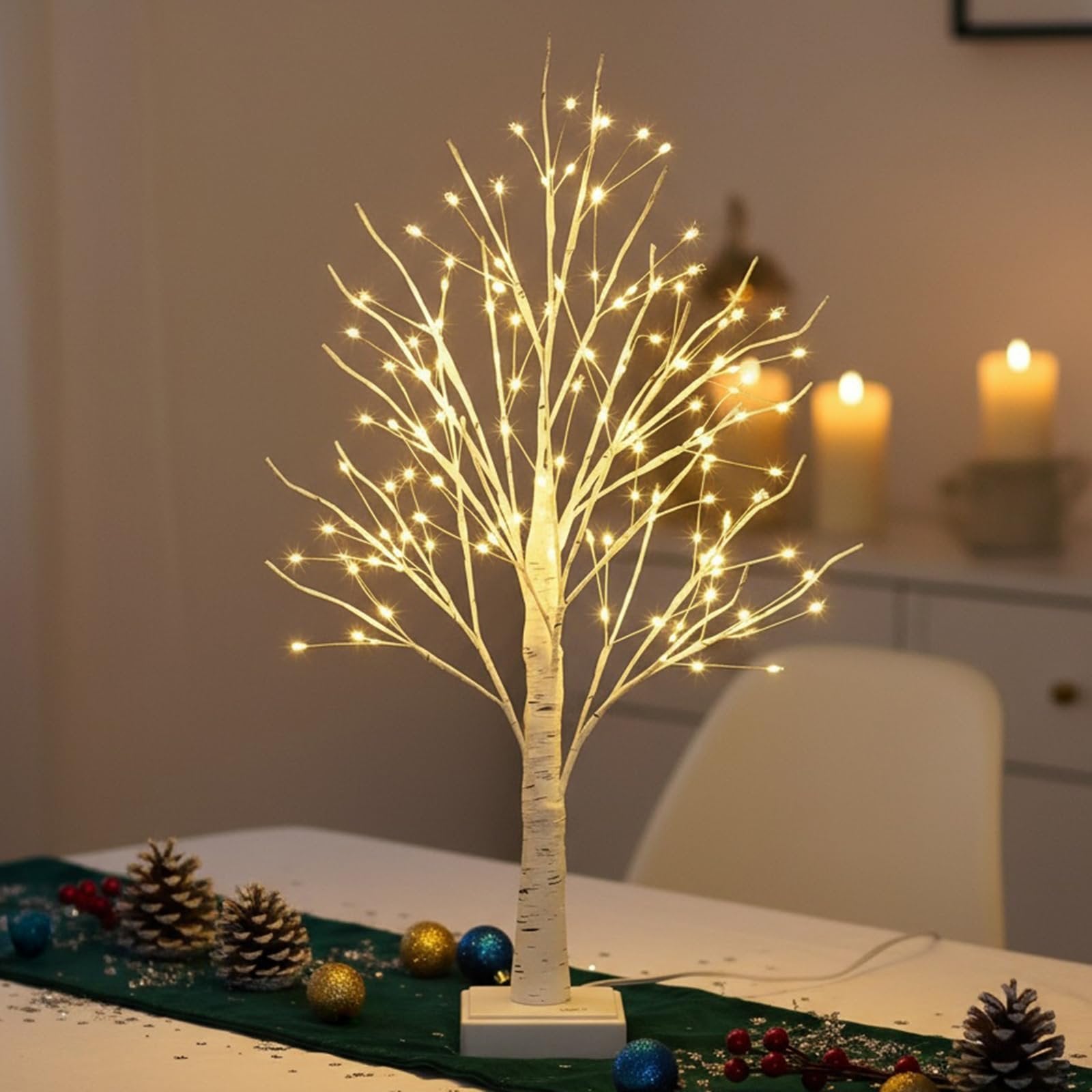 White birch tabletop tree with 144 warm white LED lights, decorated with pinecones and ornaments.