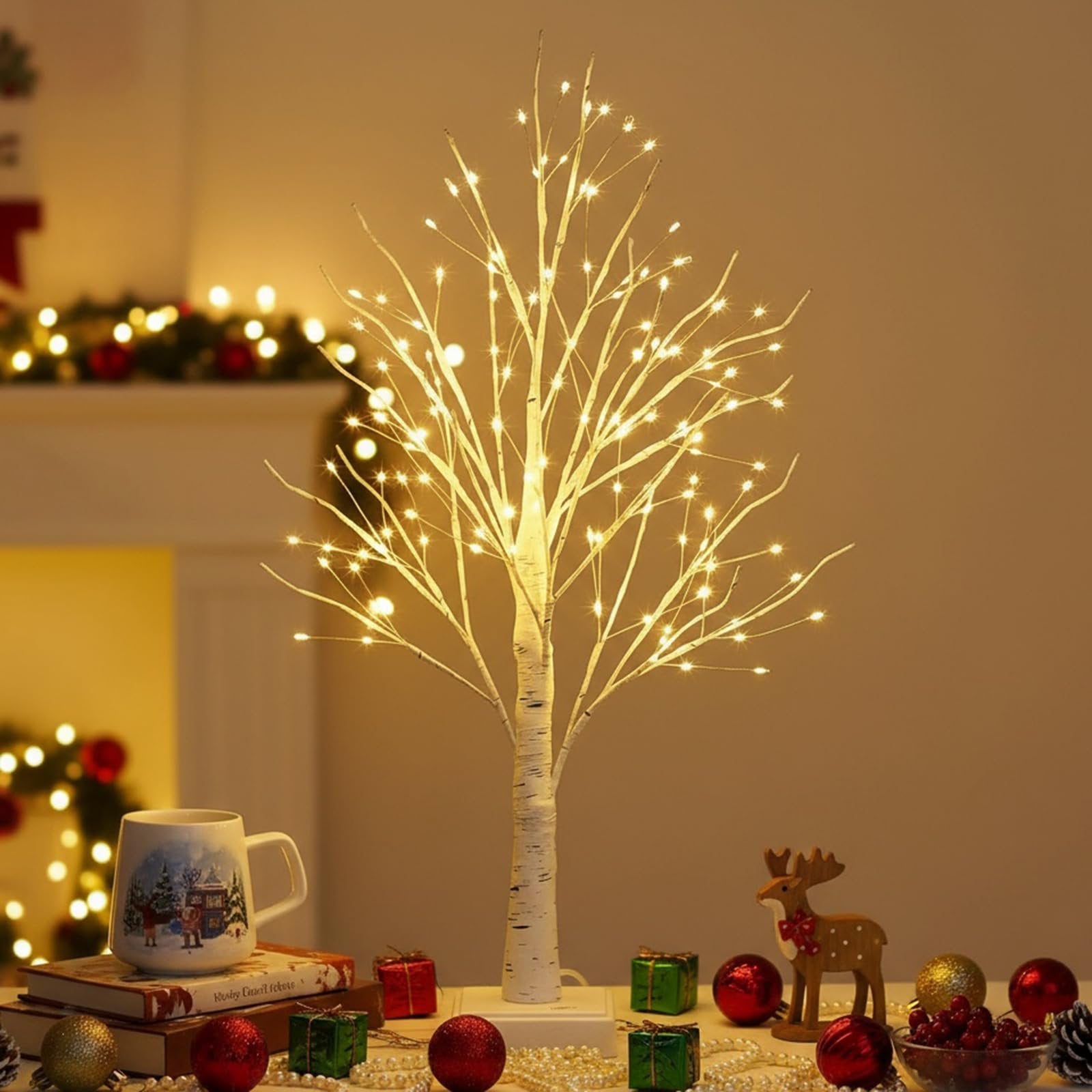 White birch LED Christmas tree with warm white lights on a table with festive decor