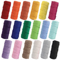Collection of 18 spools of 3-strand macrame cord in assorted colors, arranged in three rows against a white background.