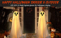 Two large lighted white cloth ghosts with string lights displayed on a porch with pumpkins and fall leaves for Halloween.