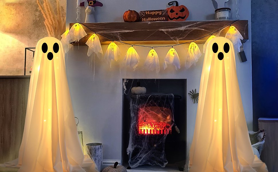 Two large lighted white cloth ghosts with string lights draped over a fireplace mantel for Halloween decor