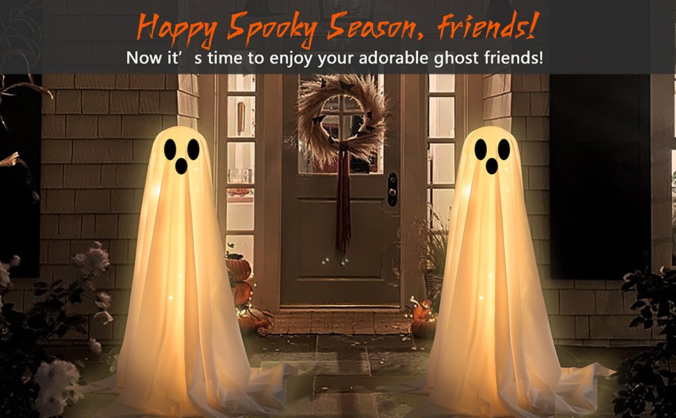 Two lighted white cloth ghost decorations with LED string lights standing on a porch at dusk, flanking a front door with a wreath.