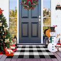 Buffalo plaid outdoor rug on a porch with a Christmas tree, gifts, and snowmen