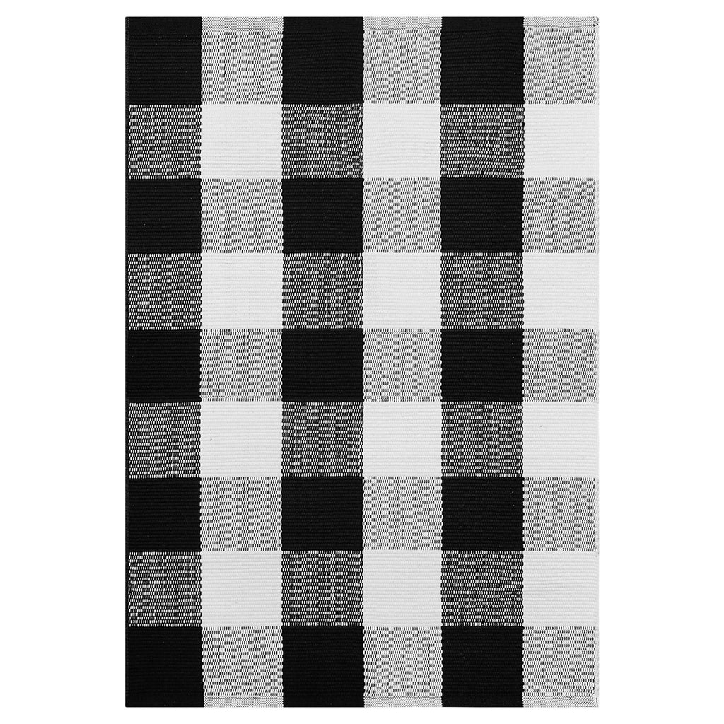Black and white buffalo plaid outdoor rug, woven cotton texture, flat lay view