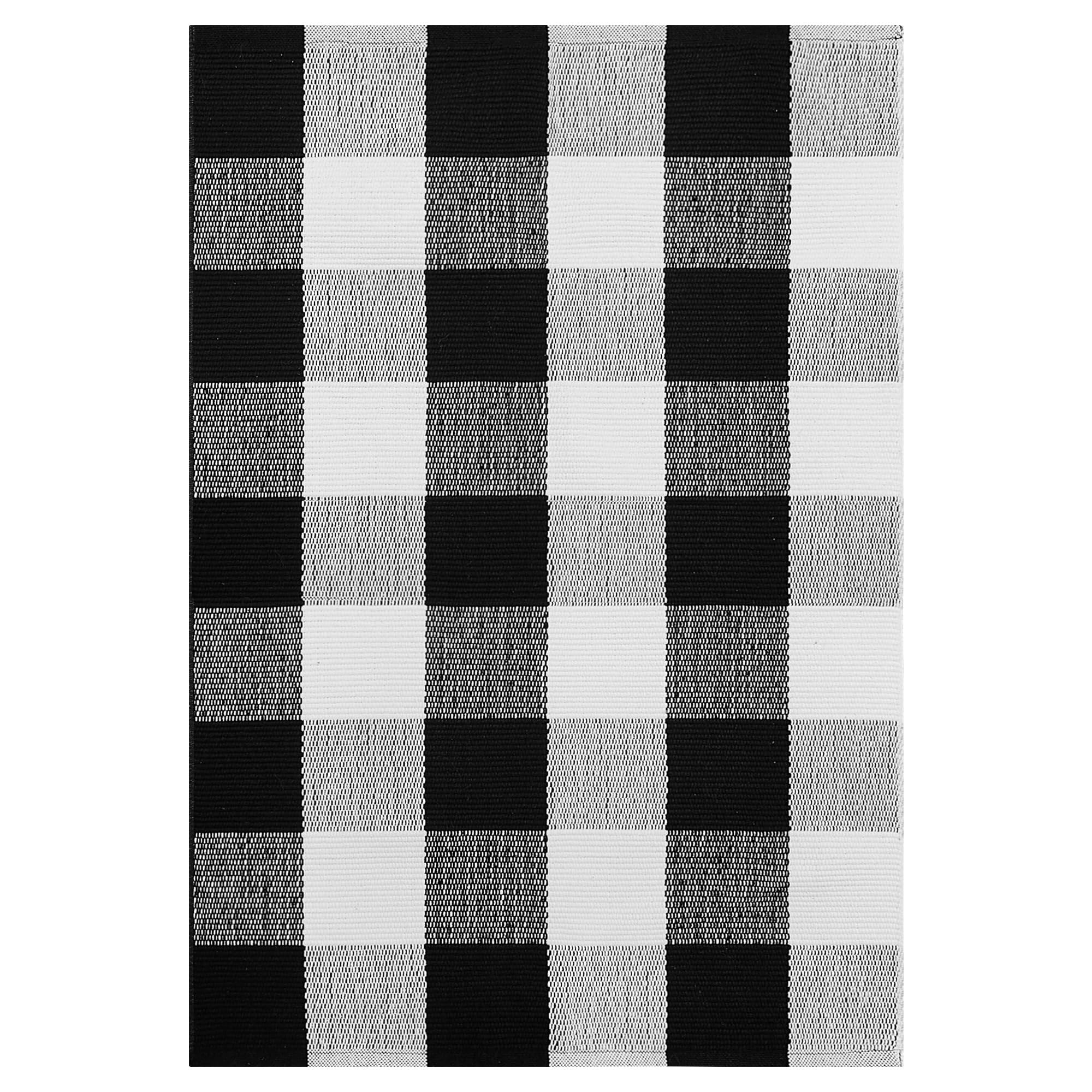 Black and white buffalo plaid outdoor rug, woven cotton texture, flat lay view