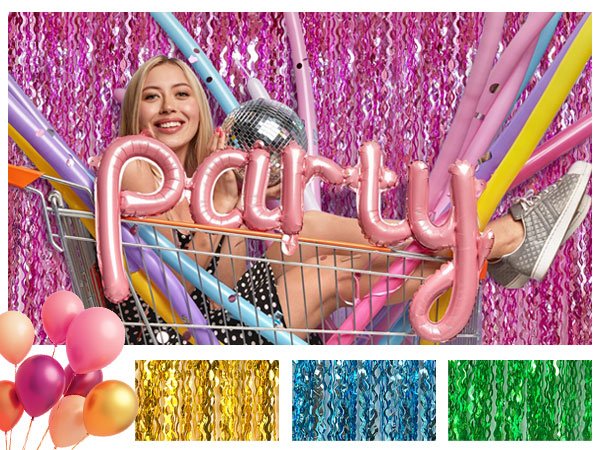 Woman in shopping cart with balloons and disco ball, pink foil fringe curtain backdrop